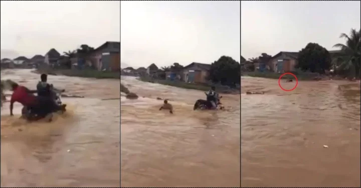 Onlookers stare helplessly as flood washes away bike rider (Video)