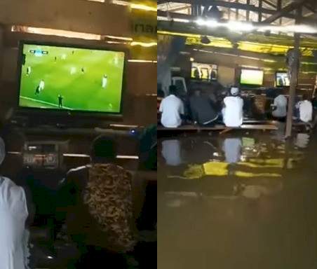 Sport enthusiasts watch football in a flooded viewing centre in Bayelsa state (video)