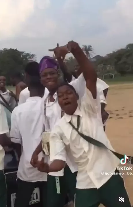 Secondary student celebrates getting a new car with his school mates
